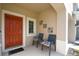 Inviting covered porch with seating area, offering a cozy outdoor space at 2087 Crystal Bell St, Orlando, FL 32824