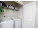 Neat laundry area with shelving, a washer, and a dryer for efficient chore management at 2087 Crystal Bell St, Orlando, FL 32824