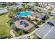 Aerial view of a community pool with playground, lounge chairs, and parking area at 2087 Crystal Bell St, Orlando, FL 32824