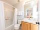 Bathroom featuring a shower and tub combination, toilet, and wooden vanity with sink and faucet at 217 Sevilla Ave, Davenport, FL 33897