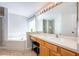 Bathroom featuring a large vanity, soaking tub and large mirror with vanity lighting at 217 Sevilla Ave, Davenport, FL 33897