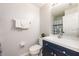 Bathroom featuring blue vanity with sink and faucet, toilet, and shower with curtain at 217 Sevilla Ave, Davenport, FL 33897