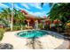 Inviting hot tub with manicured landscaping and building in the background, perfect for relaxation at 217 Sevilla Ave, Davenport, FL 33897