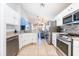 Modern kitchen with stainless steel appliances and ample counter space overlooking the dining area at 217 Sevilla Ave, Davenport, FL 33897