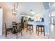 Bright kitchen with stainless steel appliances, white cabinets, and counter seating at 217 Sevilla Ave, Davenport, FL 33897