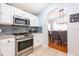 Modern kitchen with stainless steel appliances and ample counter space, adjacent to the dining area at 217 Sevilla Ave, Davenport, FL 33897