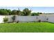 Well-maintained backyard featuring lush green grass, a white fence, and manicured landscaping at 2285 Canyon Breeze Ave, Kissimmee, FL 34746