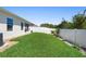 Lush backyard space with verdant grass and white fence, offering a private outdoor retreat at 2285 Canyon Breeze Ave, Kissimmee, FL 34746