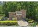 Stone community entrance sign with lush landscaping, creating an inviting welcome to the neighborhood at 2285 Canyon Breeze Ave, Kissimmee, FL 34746