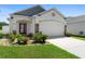 Charming single-story home showcasing a well-manicured lawn and an attached two-car garage at 2285 Canyon Breeze Ave, Kissimmee, FL 34746