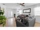 Comfortable living room featuring tile floors, a ceiling fan, and open layout with an easy flow to the kitchen at 2285 Canyon Breeze Ave, Kissimmee, FL 34746