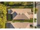 Birds eye view of the home highlighting the roof, patio, lawn, and landscaping at 2413 Park Ridge St, Apopka, FL 32712