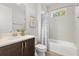 Bathroom featuring a dark wood vanity, tub and shower combo, and white tiling at 2413 Park Ridge St, Apopka, FL 32712