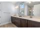 Bright bathroom with double vanity, framed mirror, and glass shower at 2413 Park Ridge St, Apopka, FL 32712