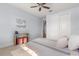 Light-filled bedroom with a ceiling fan, a bed, a side table, and closet at 2413 Park Ridge St, Apopka, FL 32712