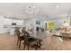 Open dining room with decorative chandelier, leading to a modern kitchen and living space at 2413 Park Ridge St, Apopka, FL 32712