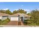 Charming single-Gathering home featuring a manicured lawn, brick driveway, and attached garage at 2413 Park Ridge St, Apopka, FL 32712