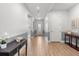 Bright hallway with wood floors, neutral paint, and stylish console table at 2413 Park Ridge St, Apopka, FL 32712