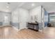 Hallway with wood floors, neutral paint, stylish console table, and front door at 2413 Park Ridge St, Apopka, FL 32712