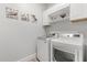 Bright laundry room with modern appliances and shelving at 2413 Park Ridge St, Apopka, FL 32712