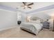 Comfortable primary bedroom featuring a tray ceiling and ensuite bathroom access at 2413 Park Ridge St, Apopka, FL 32712