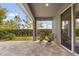 Covered patio with brick pavers, lounge chairs, and sliding glass doors to the interior at 2413 Park Ridge St, Apopka, FL 32712