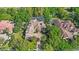 Aerial view of a luxurious estate showcasing a private pool, lush landscaping, and a grand tile roof at 25603 High Hampton Cir, Sorrento, FL 32776