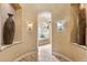 Arched entryway showcases a luxurious bathroom featuring a soaking tub and elegant decorative lighting at 25603 High Hampton Cir, Sorrento, FL 32776