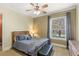 Comfortable bedroom with a wooden-frame bed, neutral decor, and window providing natural light at 25603 High Hampton Cir, Sorrento, FL 32776