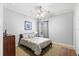 Bright bedroom with neutral color palette, ceiling fan, and a window that offers serene outdoor views at 25603 High Hampton Cir, Sorrento, FL 32776