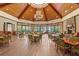 Elegant dining area with coffered wood ceiling, ambient lighting, and stone fireplace at 25603 High Hampton Cir, Sorrento, FL 32776