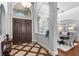 Inviting foyer that opens to the dining room with hardwood floors and plenty of natural light at 25603 High Hampton Cir, Sorrento, FL 32776