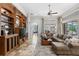 Comfortable living room featuring custom built-ins, large sectional sofa, and great natural light at 25603 High Hampton Cir, Sorrento, FL 32776