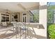 Covered outdoor bar area with barstool seating and grill overlooking an open-air pool and patio area at 25603 High Hampton Cir, Sorrento, FL 32776