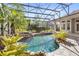 Beautiful pool featuring a stone waterfall, lush landscaping, and clear blue water, creating a tranquil oasis at 25603 High Hampton Cir, Sorrento, FL 32776