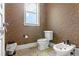 Powder room with custom wallpaper, tile flooring, toilet and bidet at 25603 High Hampton Cir, Sorrento, FL 32776