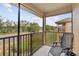 Relaxing screened-in balcony features seating and a view of the neighborhood at 302 Calabria Ave, Davenport, FL 33897