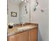 Powder room with granite countertop vanity and decorative artwork at 302 Calabria Ave, Davenport, FL 33897