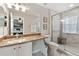 Modern bathroom with dual mirrors, granite countertop vanity, and a glass-enclosed shower at 302 Calabria Ave, Davenport, FL 33897