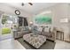 Living room featuring a sectional sofa and view to the backyard at 302 Calabria Ave, Davenport, FL 33897