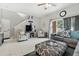 Comfortable living room with tile floors, a ceiling fan, and a sliding glass door to the backyard at 302 Calabria Ave, Davenport, FL 33897