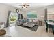 Spacious living room with large sectional, modern art, and tile flooring at 302 Calabria Ave, Davenport, FL 33897