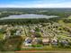 Aerial view of neighborhood, including a lake and various single Gathering homes with pools at 3138 Lee Shore Loop, Orlando, FL 32820