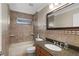 Cozy bathroom featuring granite countertops, tiled walls and vanity lighting at 3138 Lee Shore Loop, Orlando, FL 32820