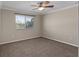 Well-lit bedroom with a ceiling fan, a large window and plush carpet at 3138 Lee Shore Loop, Orlando, FL 32820