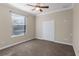 Simple bedroom with ceiling fan, closet and large window at 3138 Lee Shore Loop, Orlando, FL 32820