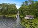 Aerial view of boat ramp with dock on a lily pad-covered lake at 3138 Lee Shore Loop, Orlando, FL 32820