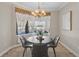 Bright breakfast nook with a pool view through the windows and elegant lighting at 3138 Lee Shore Loop, Orlando, FL 32820