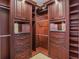 Walk-in closet featuring custom wood cabinetry, shelving, drawers, and ample space for organization at 3138 Lee Shore Loop, Orlando, FL 32820