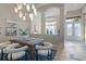 Elegant dining room featuring a modern chandelier, dark wood table, and bright front door at 3138 Lee Shore Loop, Orlando, FL 32820